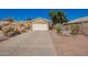 Single-story home featuring a two-car garage and desert landscaping at 2106 E 39Th Ave, Apache Junction, AZ 85119