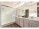 Bright bathroom features a glass shower, double sink vanity, and modern fixtures at 21402 N 158Th Dr, Sun City West, AZ 85375