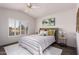 Bedroom with neutral palette, shutters, ceiling fan, and decorative bedside tables at 21402 N 158Th Dr, Sun City West, AZ 85375