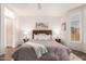 Bright bedroom features a wood headboard, soft textures, and natural light at 21402 N 158Th Dr, Sun City West, AZ 85375