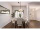 Bright dining room featuring a modern table set and views of the entryway at 21402 N 158Th Dr, Sun City West, AZ 85375