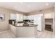 Bright kitchen featuring a granite counter, white cabinets, and recessed lighting at 21402 N 158Th Dr, Sun City West, AZ 85375