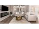 Bright living room featuring hardwood floors, a decorative fireplace and mantel, neutral color scheme, and plantation shutters at 21402 N 158Th Dr, Sun City West, AZ 85375