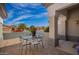 Inviting front patio featuring a glass table and metal chairs, perfect for enjoying outdoor meals and relaxing at 21402 N 158Th Dr, Sun City West, AZ 85375