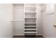 Compact, organized walk-in closet offers adjustable shelving, rod for hanging clothes at 21402 N 158Th Dr, Sun City West, AZ 85375