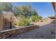 A spacious paver terrace is surrounded by landscaped borders and mature trees at 21978 N 97Th Dr, Peoria, AZ 85383