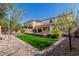 Beautiful backyard boasts manicured landscaping, synthetic grass and block wall at 21978 N 97Th Dr, Peoria, AZ 85383