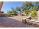 Paver terrace with stone retaining wall and manicured landscaping at 21978 N 97Th Dr, Peoria, AZ 85383