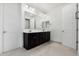 Bathroom featuring dual vanities, large mirror, and tile flooring at 21978 N 97Th Dr, Peoria, AZ 85383