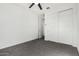 Clean bedroom featuring neutral carpet, fan, and modern closet with sliding doors at 21978 N 97Th Dr, Peoria, AZ 85383