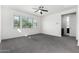 Bright bedroom featuring a ceiling fan, a window, and plush carpet at 21978 N 97Th Dr, Peoria, AZ 85383