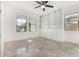 Bonus room featuring built-in shelving, tile flooring, and natural light from multiple windows at 21978 N 97Th Dr, Peoria, AZ 85383