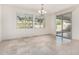 Bright dining room with a chandelier, large windows, and a sliding glass door at 21978 N 97Th Dr, Peoria, AZ 85383