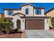 Charming two-story home with a brown garage door, blue shutters, and a well-maintained yard at 21978 N 97Th Dr, Peoria, AZ 85383