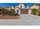 Two-story home with a well-manicured front yard and a two-car garage at 21978 N 97Th Dr, Peoria, AZ 85383