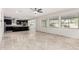 Open-concept living space with views into the kitchen, featuring sleek flooring and ample natural light at 21978 N 97Th Dr, Peoria, AZ 85383