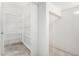 Walk-in pantry with spacious shelving and tile flooring provides ample storage at 21978 N 97Th Dr, Peoria, AZ 85383