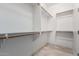 Spacious walk-in closet with plentiful built-in shelving and rod space at 21978 N 97Th Dr, Peoria, AZ 85383