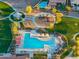 Aerial view of community pool and playground area with lush landscaping and shaded seating at 2215 E La Costa Dr, Gilbert, AZ 85298