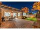 Exterior backyard at dusk with covered patio, grill, and ample seating for outdoor enjoyment at 2215 E La Costa Dr, Gilbert, AZ 85298