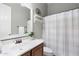 Bathroom featuring single vanity and shower with white curtain, creating a simple and functional space at 2215 E La Costa Dr, Gilbert, AZ 85298