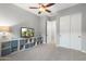 Neutral bedroom with a ceiling fan, TV, and storage, showcasing a cozy and organized space at 2215 E La Costa Dr, Gilbert, AZ 85298