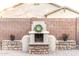 Outdoor fireplace featuring stone accents and brick-paved flooring, enhancing the backyard's ambiance at 2215 E La Costa Dr, Gilbert, AZ 85298