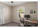 Neutral-toned bedroom featuring a ceiling fan, window, and a desk work area at 2219 N 13Th St, Phoenix, AZ 85006