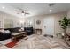 Spacious living room features herringbone flooring, a ceiling fan, and natural light at 2219 N 13Th St, Phoenix, AZ 85006