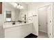 Bright bathroom with double sinks, a large mirror, and white cabinets at 22962 N 182Nd Ln, Surprise, AZ 85387