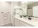 Modern bathroom with double sinks, sleek fixtures, and a large mirror at 22962 N 182Nd Ln, Surprise, AZ 85387