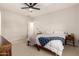 Minimalist bedroom with neutral carpet, ceiling fan, white walls and trim, and two side tables at 22962 N 182Nd Ln, Surprise, AZ 85387