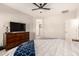 Neutral bedroom with dresser, ceiling fan, and an open doorway to the bath at 22962 N 182Nd Ln, Surprise, AZ 85387