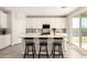 Modern white kitchen featuring a large island with barstool seating and stainless steel appliances at 22962 N 182Nd Ln, Surprise, AZ 85387