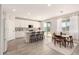 Modern kitchen featuring white cabinets, a center island with seating, and tile floors at 22962 N 182Nd Ln, Surprise, AZ 85387