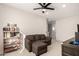 Relaxing living room with a sofa, bookshelf, and neutral color scheme at 22962 N 182Nd Ln, Surprise, AZ 85387