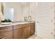 Bathroom with decorative wallpaper, granite countertops, and dark brown cabinets at 23193 E Nightingale Rd, Queen Creek, AZ 85142