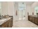 Bathroom featuring double sinks, granite countertops, tile floors, and a walk-in shower at 23193 E Nightingale Rd, Queen Creek, AZ 85142