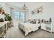 Serene bedroom with a metal bed frame, neutral tones, stylish decor, and ample natural light at 23193 E Nightingale Rd, Queen Creek, AZ 85142