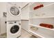 Efficient laundry area with stacked washer and dryer, plus shelving for organized linen storage at 23193 E Nightingale Rd, Queen Creek, AZ 85142