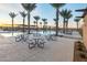 Outdoor picnic area near community pool featuring tables with benches at 23193 E Nightingale Rd, Queen Creek, AZ 85142