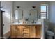 Modern bathroom with dual sinks, vanity, a window, and a shower at 2393 E San Gabriel Trl, Casa Grande, AZ 85194