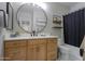 Bathroom featuring a wood vanity with black hardware and modern fixtures, along with a shower and tub at 2393 E San Gabriel Trl, Casa Grande, AZ 85194