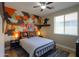 Nicely decorated bedroom with decorative wall accents, a ceiling fan, and a window at 2393 E San Gabriel Trl, Casa Grande, AZ 85194