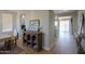 Elegant dining area showcasing hardwood floors and a vintage cabinet with a charming arched hallway at 2393 E San Gabriel Trl, Casa Grande, AZ 85194