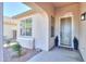 Inviting covered front porch with decorative plants, a 'Home Sweet Home' mat, and a charming window box feature at 2393 E San Gabriel Trl, Casa Grande, AZ 85194