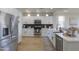 Bright kitchen with stainless steel appliances, white cabinetry, and a stylish farmhouse sink at 2393 E San Gabriel Trl, Casa Grande, AZ 85194