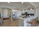 Open-concept kitchen featuring white cabinets, stainless steel appliances, and a breakfast bar with seating at 2393 E San Gabriel Trl, Casa Grande, AZ 85194