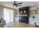 Living room featuring a modern electric fireplace and custom built-in shelving, and backyard access at 2393 E San Gabriel Trl, Casa Grande, AZ 85194