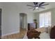 Bright main bedroom with a dark dresser, ceiling fan, and patio access at 2393 E San Gabriel Trl, Casa Grande, AZ 85194